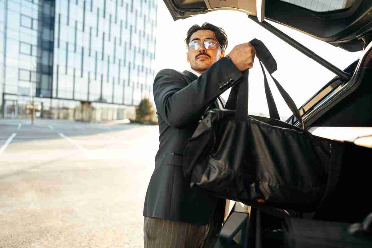 Professional Chauffeur Assisting with Luggage Professional Chauffeur Assisting with Luggage